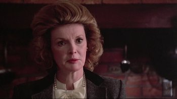 Movie still from “El Norte” (1983), directed by Gregory Nava – An older woman wearing a jacket and a bow tie; Close Up shot, Low angle