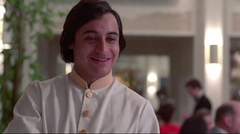 Movie still from “El Norte” (1983), directed by Gregory Nava – A man in a chef's outfit smiling for the camera; Close Up shot, Low angle