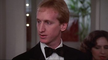 Movie still from “El Norte” (1983), directed by Gregory Nava – A person wearing a suit and a bow tie; Close Up shot, Low angle