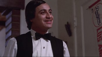 Movie still from “El Norte” (1983), directed by Gregory Nava – A man wearing a black vest and a bow tie; Close Up shot, Low angle