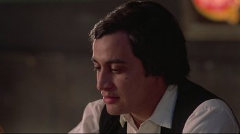 Movie still from “El Norte” (1983), directed by Gregory Nava – A person wearing a suit and tie; Close Up shot, Low angle