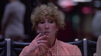 Movie still from “El Norte” (1983), directed by Gregory Nava – A woman smoking a cigarette while sitting down; Close Up shot, Low angle