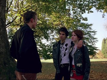 Movie still from “Elephant” (2003), directed by Gus Van Sant – A group of people standing next to each other in a park; Medium shot, Over the shoulder angle