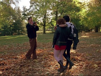 Movie still from “Elephant” (2003), directed by Gus Van Sant – A man and two women in a park; Wide shot, Low angle
