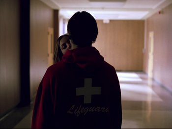 Movie still from “Elephant” (2003), directed by Gus Van Sant – A couple of people that are in a room; Medium shot, Over the shoulder angle