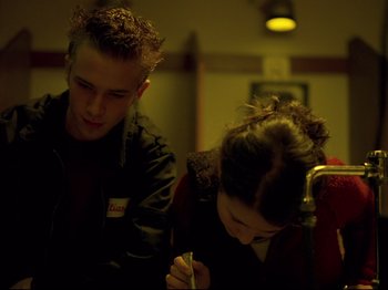 Movie still from “Elephant” (2003), directed by Gus Van Sant – A man and a woman sitting next to each other on a train; Close Up shot, Low angle