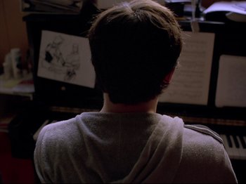 Movie still from “Elephant” (2003), directed by Gus Van Sant – A man sitting in front of a computer monitor; Close Up shot, Over the shoulder angle