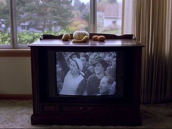 Movie still from “Elephant” (2003), directed by Gus Van Sant – A television set with bread on top of it; Medium shot, High angle