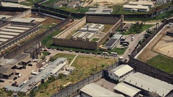 Movie still from “Elite Squad 2: The Enemy Within” (2010), directed by José Padilha – An aerial view of an industrial area in a city; Extreme Wide shot, High angle