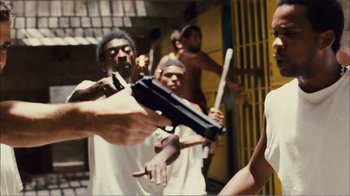 Movie still from “Elite Squad 2: The Enemy Within” (2010), directed by José Padilha – A group of men standing next to each other holding guns; Medium shot, Over the shoulder angle