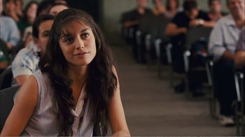 Movie still from “Elite Squad 2: The Enemy Within” (2010), directed by José Padilha – A woman sitting in front of a group of people; Close Up shot, Over the shoulder angle