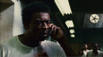 Movie still from “Elite Squad 2: The Enemy Within” (2010), directed by José Padilha – A man with blood all over his face talking on a cell phone; Close Up shot, Low angle