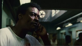 Movie still from “Elite Squad 2: The Enemy Within” (2010), directed by José Padilha – A man is talking on a cell phone; Close Up shot, Low angle