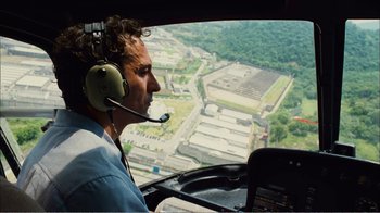 Movie still from “Elite Squad 2: The Enemy Within” (2010), directed by José Padilha – A man in a helicopter looking out over a city; Medium shot, High angle