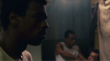 Movie still from “Elite Squad 2: The Enemy Within” (2010), directed by José Padilha – Two men sitting in front of each other in a dark room; Close Up shot, Over the shoulder angle