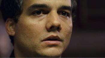 Movie still from “Elite Squad 2: The Enemy Within” (2010), directed by José Padilha – A man's face with a lot of wrinkles on his face; Close Up shot, Low angle