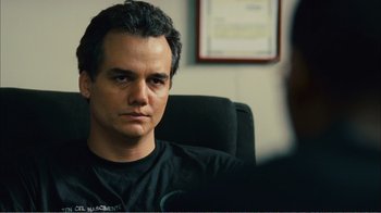Movie still from “Elite Squad 2: The Enemy Within” (2010), directed by José Padilha – A man sitting in front of another man in an office; Close Up shot, Over the shoulder angle