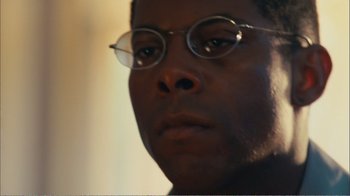 Movie still from “Elite Squad 2: The Enemy Within” (2010), directed by José Padilha – A person wearing glasses; Close Up shot, Low angle