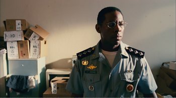 Movie still from “Elite Squad 2: The Enemy Within” (2010), directed by José Padilha – A man in a uniform is standing in a room; Close Up shot, Low angle