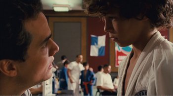 Movie still from “Elite Squad 2: The Enemy Within” (2010), directed by José Padilha – Two young men are facing each other in a room; Close Up shot, Over the shoulder angle