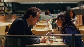 Movie still from “Elite Squad 2: The Enemy Within” (2010), directed by José Padilha – A man and a woman sitting at a table talking to each other; Medium shot, Over the shoulder angle