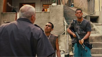 Movie still from “Elite Squad 2: The Enemy Within” (2010), directed by José Padilha – A group of men standing next to each other on a street; Medium shot, Over the shoulder angle