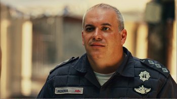 Movie still from “Elite Squad 2: The Enemy Within” (2010), directed by José Padilha – A person wearing a uniform; Close Up shot, Over the shoulder angle