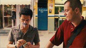 Movie still from “Elite Squad 2: The Enemy Within” (2010), directed by José Padilha – Two men standing next to each other on the street; Medium shot, Low angle