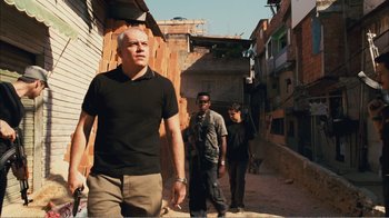 Movie still from “Elite Squad 2: The Enemy Within” (2010), directed by José Padilha – A man walking down a street with two other men; Medium shot, Low angle