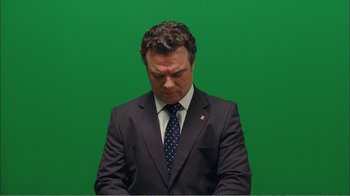 Movie still from “Elite Squad 2: The Enemy Within” (2010), directed by José Padilha – A man in a suit and tie looking down; Medium shot, High angle