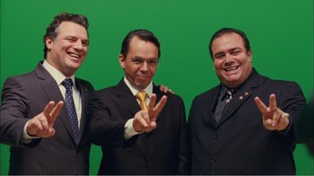 Movie still from “Elite Squad 2: The Enemy Within” (2010), directed by José Padilha – A group of men in suits standing next to each other; Medium shot, High angle