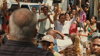 Movie still from “Elite Squad 2: The Enemy Within” (2010), directed by José Padilha – A group of people standing in the street with their hands up; Medium shot, Over the shoulder angle