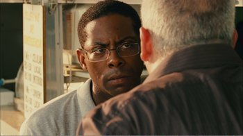 Movie still from “Elite Squad 2: The Enemy Within” (2010), directed by José Padilha – A person looking at a mirror; Close Up shot, Over the shoulder angle