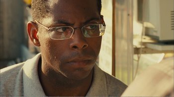 Movie still from “Elite Squad 2: The Enemy Within” (2010), directed by José Padilha – A person wearing glasses; Close Up shot, Over the shoulder angle
