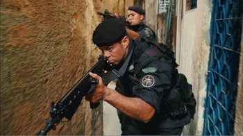 Movie still from “Elite Squad 2: The Enemy Within” (2010), directed by José Padilha – Two men in black uniforms are holding guns; Medium shot, Low angle