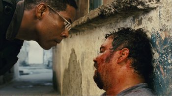Movie still from “Elite Squad 2: The Enemy Within” (2010), directed by José Padilha – Two men are looking at each other with blood on their face; Close Up shot, Over the shoulder angle