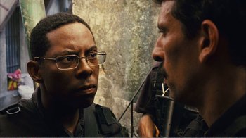 Movie still from “Elite Squad 2: The Enemy Within” (2010), directed by José Padilha – A man with glasses is looking at another man with glasses; Close Up shot, Over the shoulder angle
