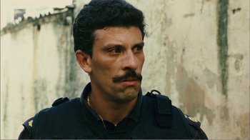 Movie still from “Elite Squad 2: The Enemy Within” (2010), directed by José Padilha – A person with a mustache; Close Up shot, Over the shoulder angle