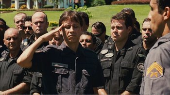 Movie still from “Elite Squad 2: The Enemy Within” (2010), directed by José Padilha – A man saluting in front of a group of people; Medium shot, Low angle