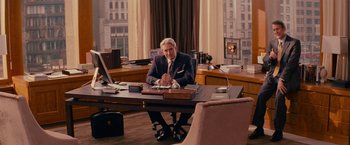 Movie still from “The Proposal” (2009), directed by Anne Fletcher – A man sitting at a desk in front of a computer; Wide shot, Over the shoulder angle