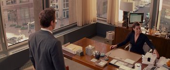 Movie still from “The Proposal” (2009), directed by Anne Fletcher – Two people are sitting at a table in a room; Medium shot, Over the shoulder angle