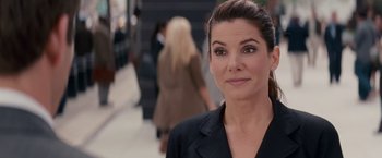 Movie still from “The Proposal” (2009), directed by Anne Fletcher – A person wearing a suit; Close Up shot, Over the shoulder angle