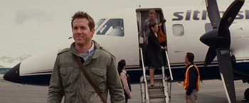 Movie still from “The Proposal” (2009), directed by Anne Fletcher – A group of people getting off of a plane; Medium shot, Over the shoulder angle