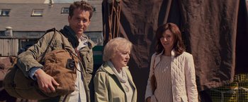 Movie still from “The Proposal” (2009), directed by Anne Fletcher – A group of people standing next to each other; Medium shot, Over the shoulder angle