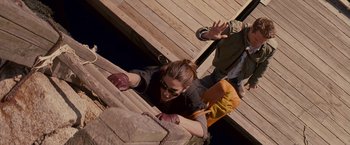 Movie still from “The Proposal” (2009), directed by Anne Fletcher – A woman climbing up a wooden ramp on a bridge; Wide shot, Overhead angle