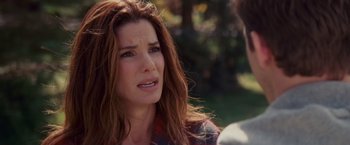 Movie still from “The Proposal” (2009), directed by Anne Fletcher – A person with long red hair; Close Up shot, Over the shoulder angle