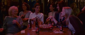 Movie still from “The Proposal” (2009), directed by Anne Fletcher – A group of people sitting at a table with food; Medium shot, Over the shoulder angle