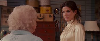 Movie still from “The Proposal” (2009), directed by Anne Fletcher – A woman in a white shirt is talking to another woman; Close Up shot, Over the shoulder angle