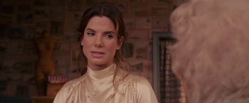 Movie still from “The Proposal” (2009), directed by Anne Fletcher – A person wearing a dress; Close Up shot, Over the shoulder angle