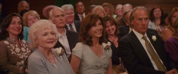 Movie still from “The Proposal” (2009), directed by Anne Fletcher – A group of people sitting in front of each other; Medium shot, Over the shoulder angle